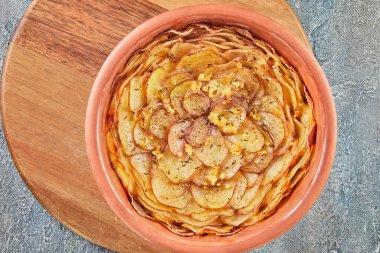Potato pie with garlic and thyme on wooden board. Flat lay