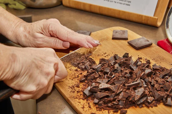 Chef Cuts Bitter Chocolate Pieces Wooden Board Kitchen — Stockfoto