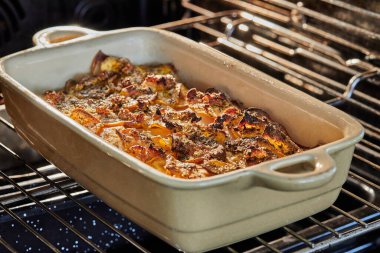 Potato and sweet potato gratin with Provence herbs is baked in the oven. French gourmet cuisine.
