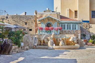 Central square of old Jaffa with fountain of zodiac signs, restaurants and the Church of St. Peter the Apostle.
