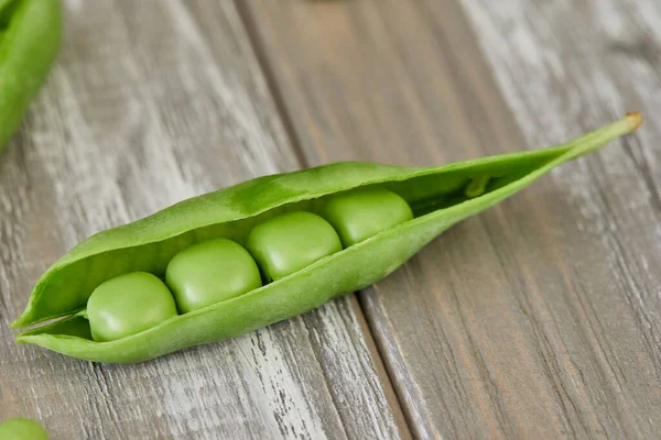Opened Pods Fresh Green Peas Wooden Background — Stockfoto