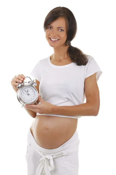 Retrato de uma mulher grávida com um despertador — Fotografia de Stock