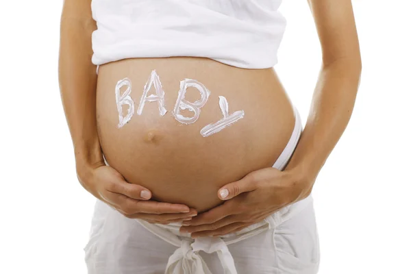 Porträtt av en gravid kvinna med en skylt på magen - "baby" — Stockfoto
