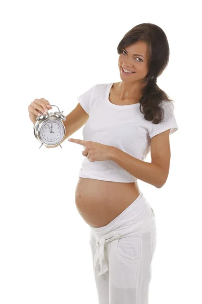 Portrait of a pregnant woman with an alarm clock Stock Image