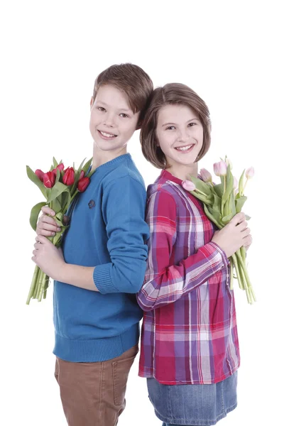 Portrait of a girl and a boy with a bouquet of tulips — Stock Photo, Image