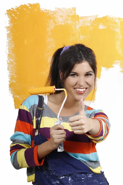 Attractive young woman with paint brush renovating — Stock Photo, Image