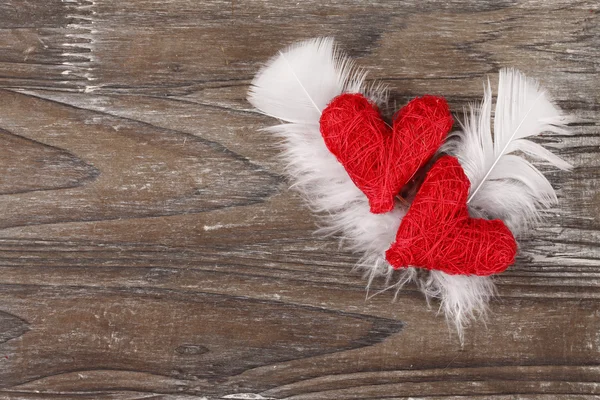 Red hearts with white feathers — Stock Photo, Image