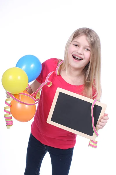 Cute girl with black board and balloons — Stock Photo, Image