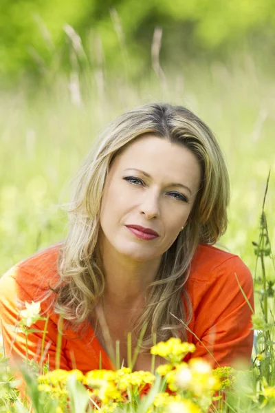 Pretty woman middle aged in flower field — Stock Photo, Image