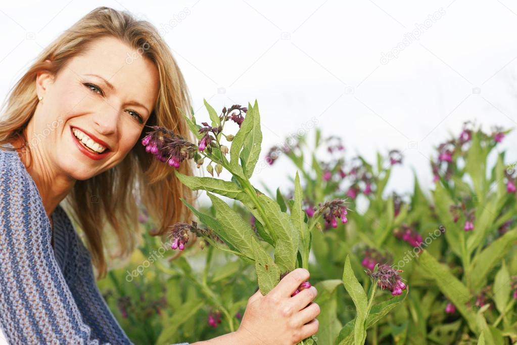Happy woman with herbal remedy