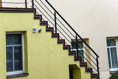 Pencereli koyu kahverengi parmaklıklı sarı köşegen merdiven