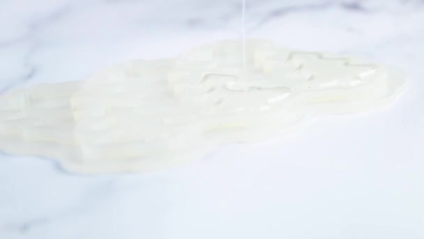 투명 한 캐러멜 을 흰 대리석 배경 위에 얇은 시냇물, 즉 크리스마스 나무 모양의 주형 이 있는 흰 실리콘 주형에 붓는다 — 비디오