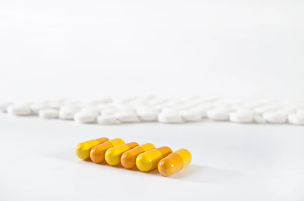 Medical background - orange and white pills — Stock Photo, Image