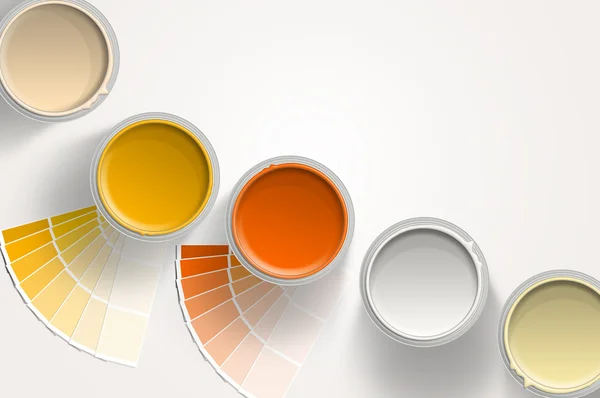 五个油漆罐-黄色、 橙色、 白色白色背景上 图库照片