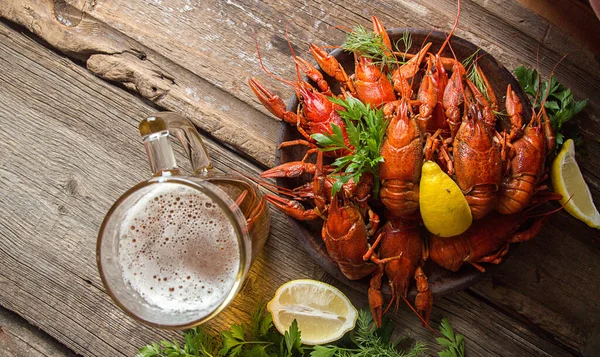 Beer party. Still life with glass of beer, crayfish crawfish against old wooden rustic background. Top view. Overhead. Copy space.