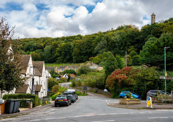 The Cotswold village of North Nibley showing the Black Horse public house and on the hill, the Tyndale Monument, Gloucestershire, England, United Kingdom