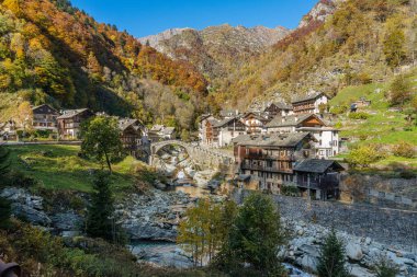 The beautiful village of Rassa, during fall season, in Valsesia (Sesia Valley). Province of Vercelli, Piedmont, Italy. clipart