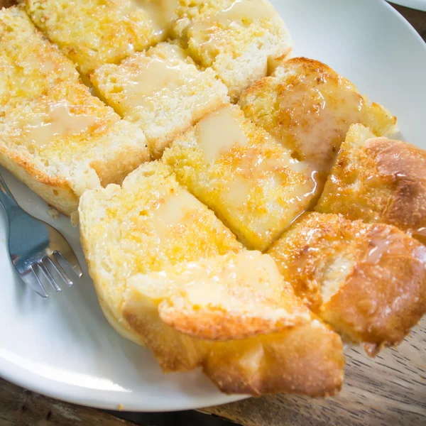 Bread toast and condensed milk with sugar — Stock Photo, Image