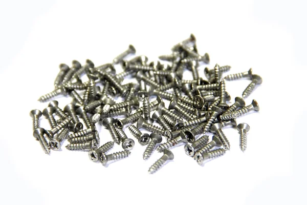 Many short screws on white background — Stock Photo, Image