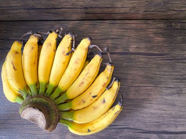 Golden Banana ready to eat on the wooden table 