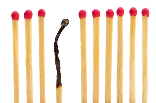 Matches on a row with one burned — Stock Photo, Image