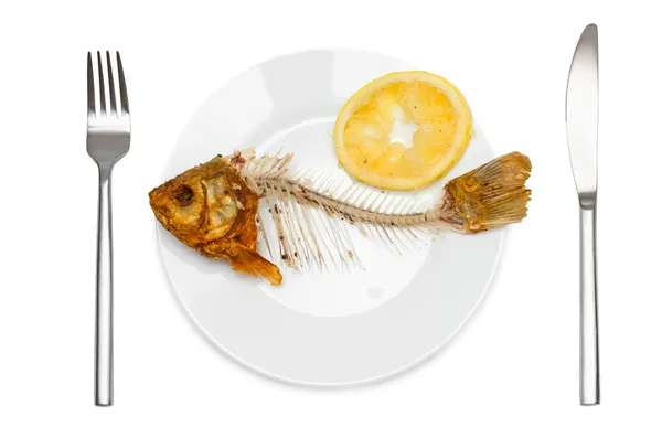 Fish skeleton with squeezed lemon — Stock Photo, Image