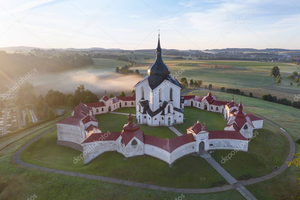 Aerial view of the church St. John of Nepomuk. Zdar nad Sazavou. The Pilgrim Church of Zelena hora. UNESCO World Heritage Site in beautiful golden morning light at sunrise in fall, Czech Republic
