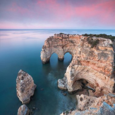 Okyanusun üzerindeki doğal kemer. Marinha sahilindeki doğal mağaralar, Algarve, Lagoa Portekiz. Sahilde taş kemer. Yaz mevsimi.