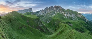 Panoramic image of Italian Dolomites with famous peaks and chalets, South Tyrol, Italy, Europe at summer sunset. Awesome sunny Landscape. Dolomite Alps.