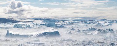 Climate change and global warming. Icebergs from a melting glacier in Ilulissat Glacier, Greenland. The icy landscape of the Arctic nature in the UNESCO world heritage site.