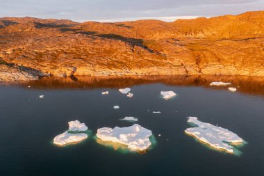 Climate change and global warming. Icebergs from a melting glacier in Ilulissat Glacier, Greenland. The icy landscape of the Arctic nature in the UNESCO world heritage site.