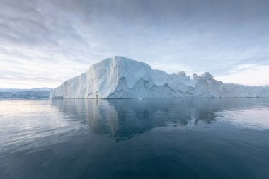 Climate change and global warming. Icebergs from a melting glacier in Ilulissat Glacier, Greenland. The icy landscape of the Arctic nature in the UNESCO world heritage site.