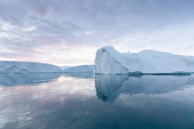 Climate change and global warming. Icebergs from a melting glacier in Ilulissat Glacier, Greenland. The icy landscape of the Arctic nature in the UNESCO world heritage site.