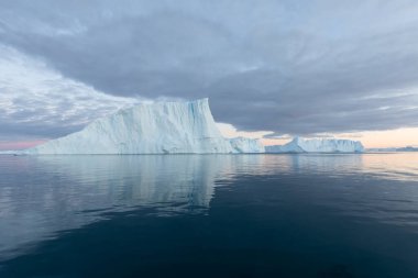 Climate change and global warming. Icebergs from a melting glacier in Ilulissat Glacier, Greenland. The icy landscape of the Arctic nature in the UNESCO world heritage site.
