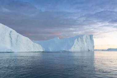 Climate change and global warming. Icebergs from a melting glacier in Ilulissat Glacier, Greenland. The icy landscape of the Arctic nature in the UNESCO world heritage site.