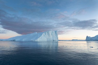 Climate change and global warming. Icebergs from a melting glacier in Ilulissat Glacier, Greenland. The icy landscape of the Arctic nature in the UNESCO world heritage site.
