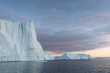 Climate change and global warming. Icebergs from a melting glacier in Ilulissat Glacier, Greenland. The icy landscape of the Arctic nature in the UNESCO world heritage site.