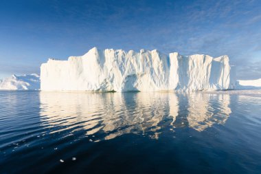 Climate change and global warming. Icebergs from a melting glacier in Ilulissat Glacier, Greenland. The icy landscape of the Arctic nature in the UNESCO world heritage site.