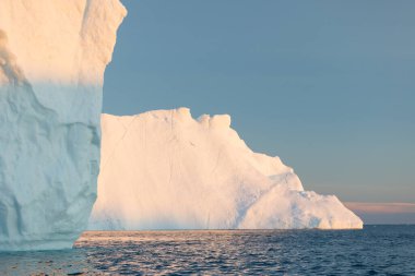 Climate change and global warming. Icebergs from a melting glacier in Ilulissat Glacier, Greenland. The icy landscape of the Arctic nature in the UNESCO world heritage site.