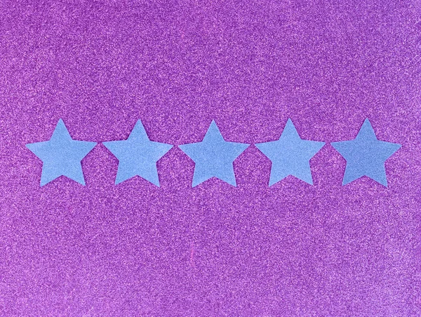 Five Star Rating on pink background. Blue glitter stars. ranking concept