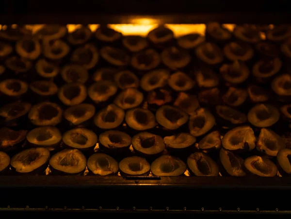 Dried plum. Plum cut in half, pitted, cooked in the oven at a low temperature for a long time. Selective focus.