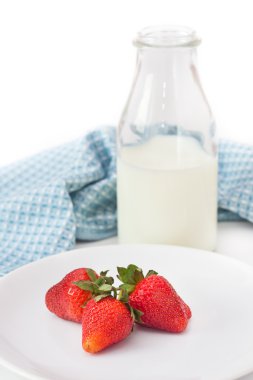 Milk in the bottle with strawberries