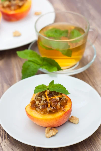 Peach dessert and cup of tea — Stock Photo, Image