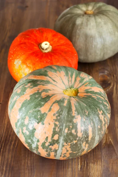 Autumn pumpkins on wooden background — Stock Photo, Image