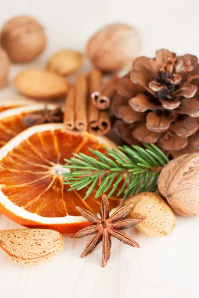 Different kinds of nuts, spices and dried oranges — Stock Photo, Image