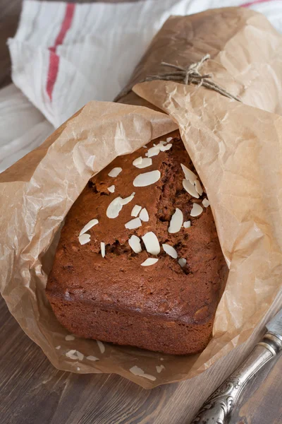 Banana bread with almond in baking paper — Stock Photo, Image