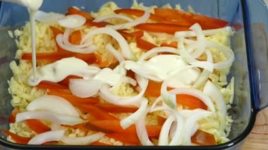 Pouring white sauce in the pot. Cooking the lunch, mozzarella cheese, spianchs,sweet pepper and white sauce