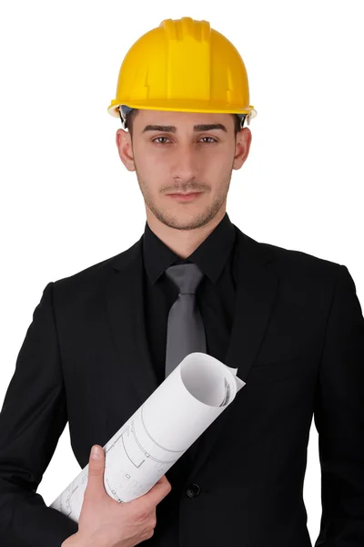 Uomo con Hard Hat Holding arrotolato progetti — Foto Stock