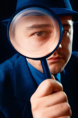 Man Looking through Magnifying Glass clipart