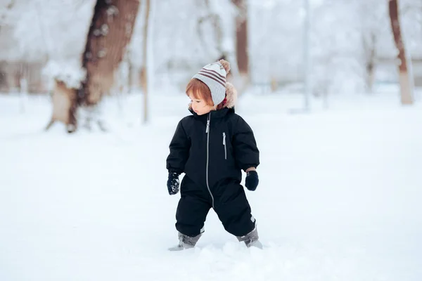 Adorable Baby Girl Standing Snow Wearing Warm Clothes — Stock Photo, Image